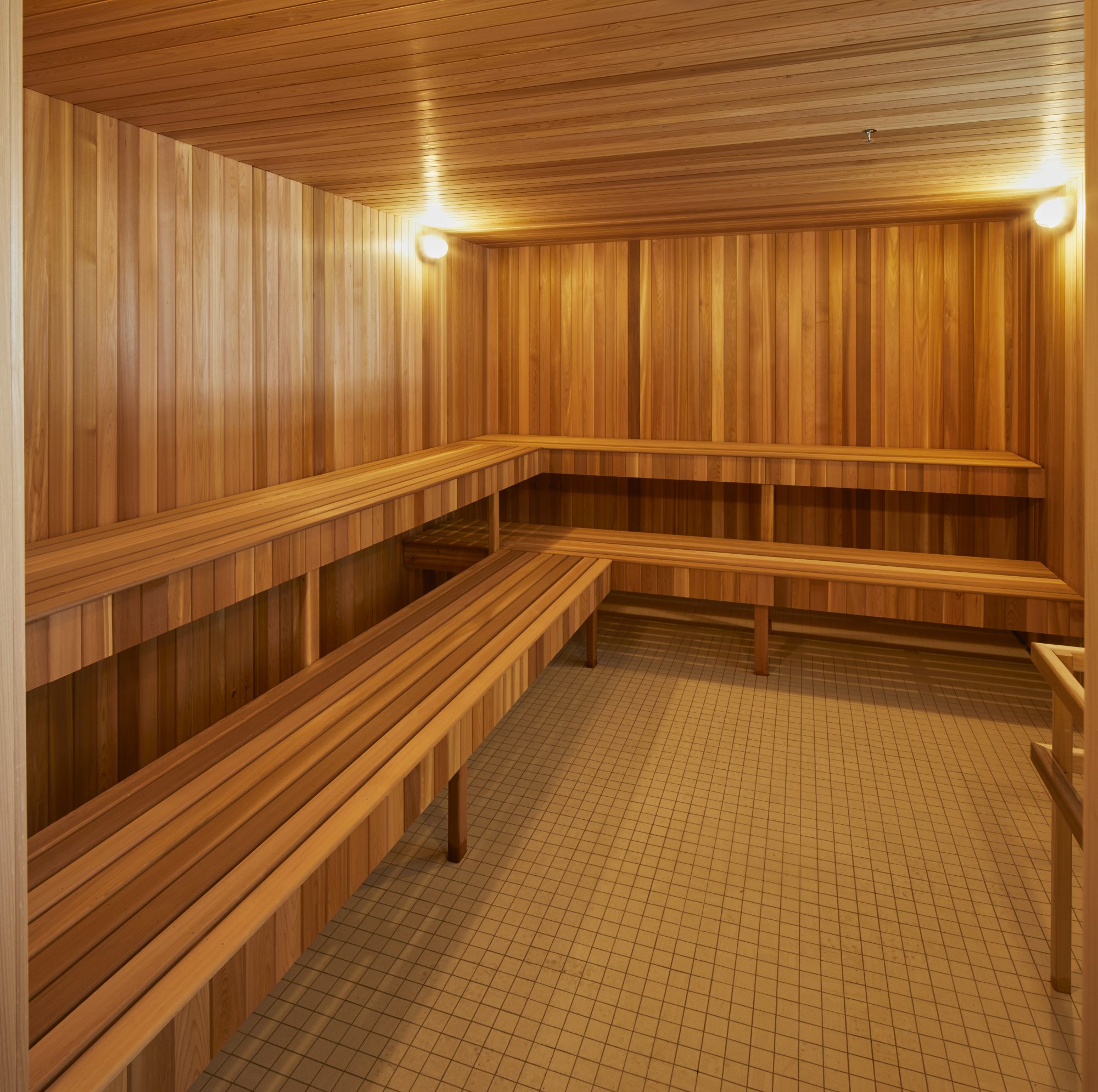 Sauna with warm wood and tile flooring.